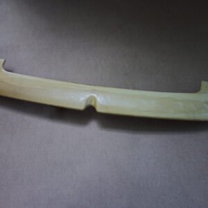 Unfinished rear hatch spoiler for a Volkswagen MK4 wagon photographed on cardboard